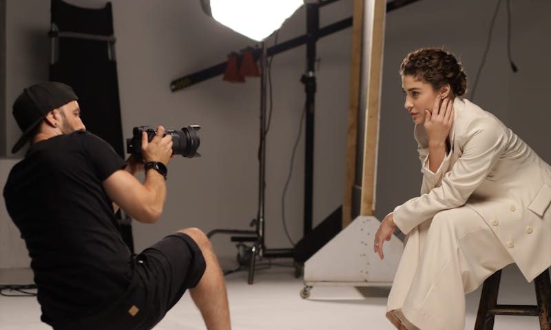 Photographer Taking Pictures of a Woman in a Studio