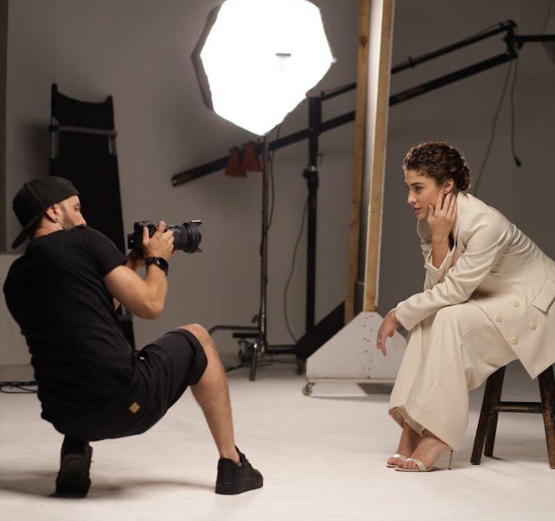 Photographer Taking Pictures of a Woman in a Studio